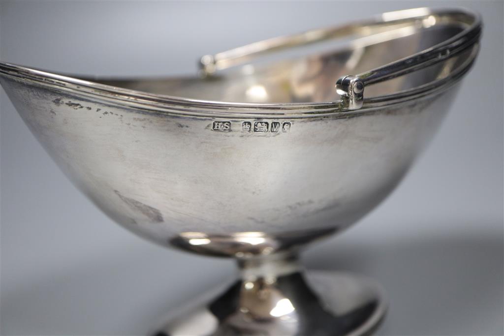 A Victorian oval silver swing-handled sugar basket, having thread edge, Sheffield, 1888, height 10.3cm, 5oz.